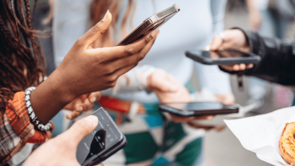 Phones being held by people in group